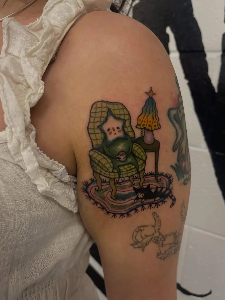 Charming gnome in a cozy chair tattoo