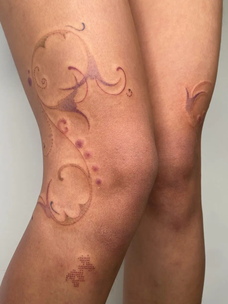 Elegant floral knee tattoo design with subtle hues