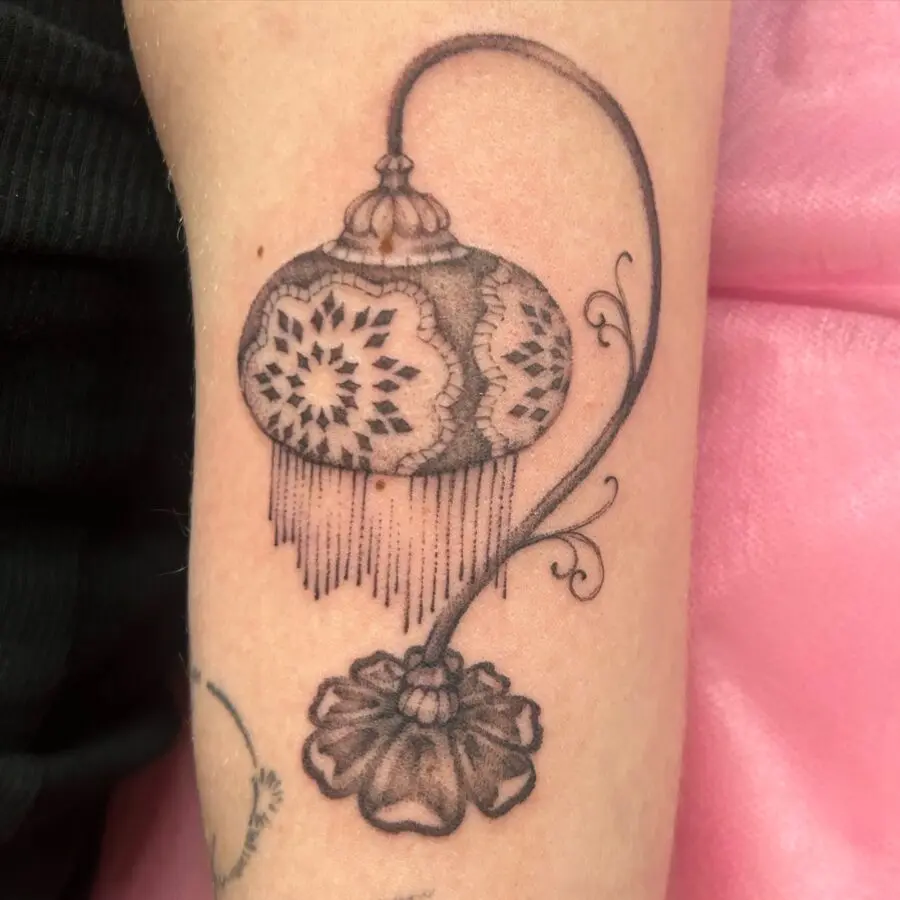 Elegant lantern tattoo with floral accents