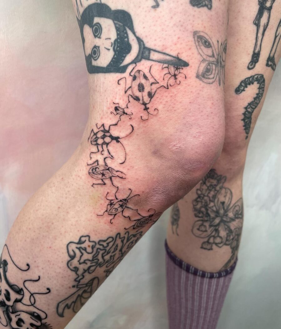 Whimsical knee tattoos with floral elements
