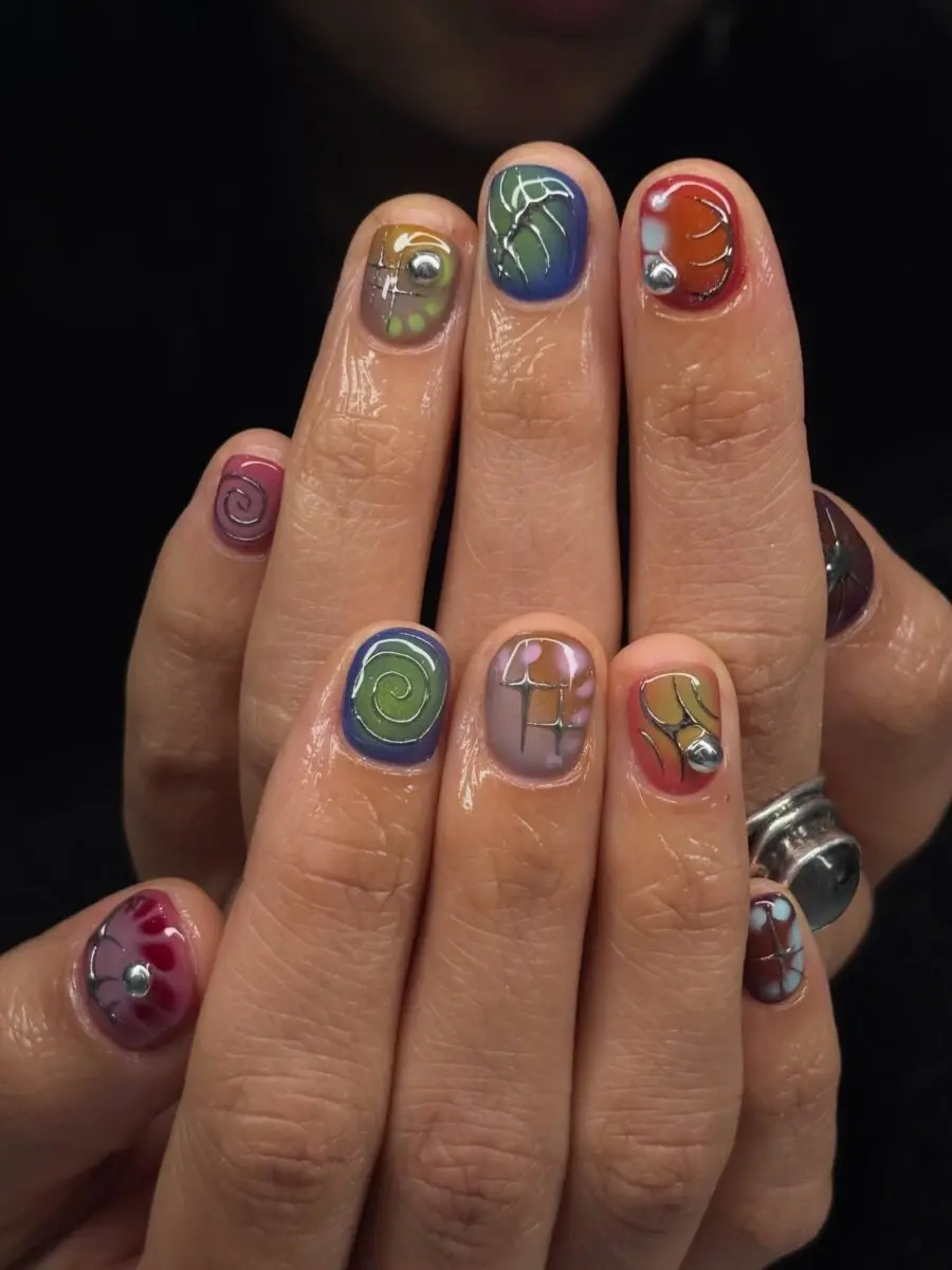 Vibrant Y2K Nail Art with Swirls and Shapes