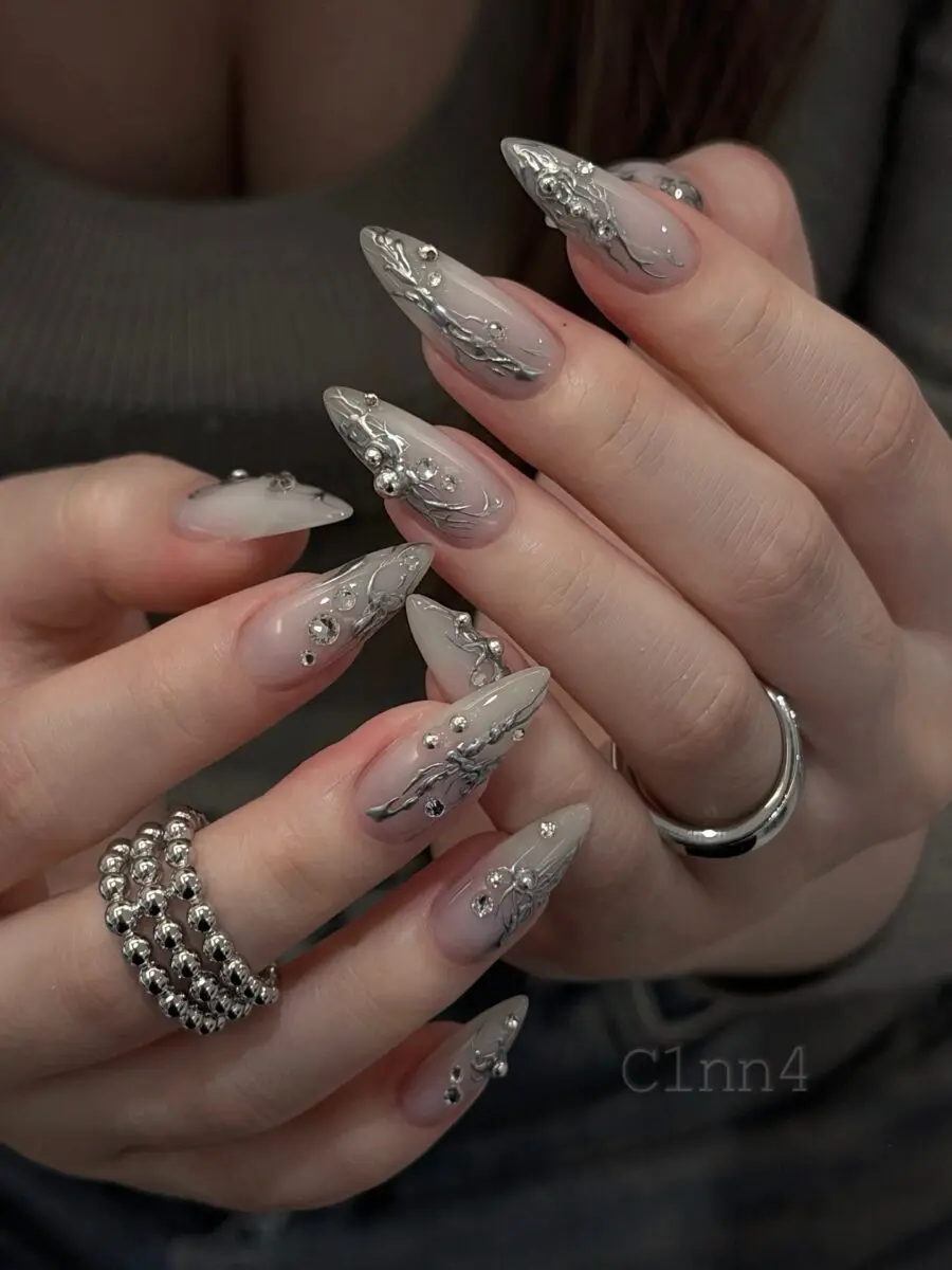 Elegant stiletto nails adorned with silver accents