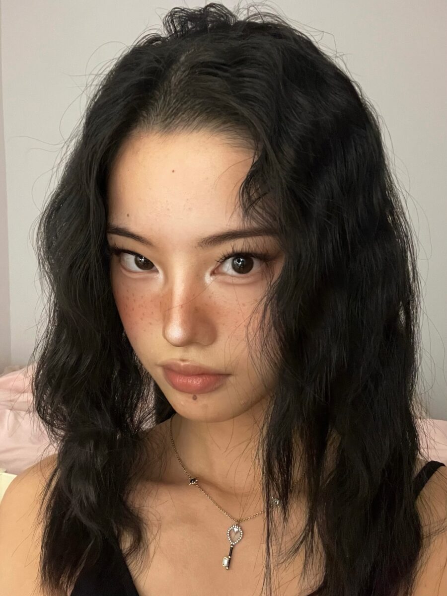 Chic wavy hair and radiant skin details