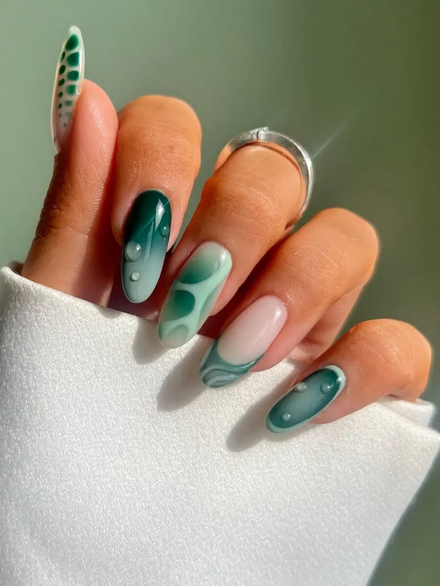Elegant almond-shaped teal nail art design