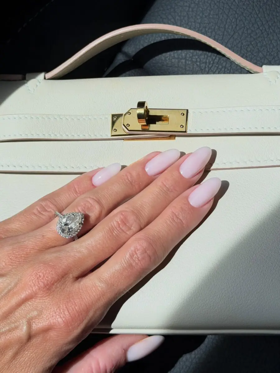 Chic almond nails complement luxury handbag style