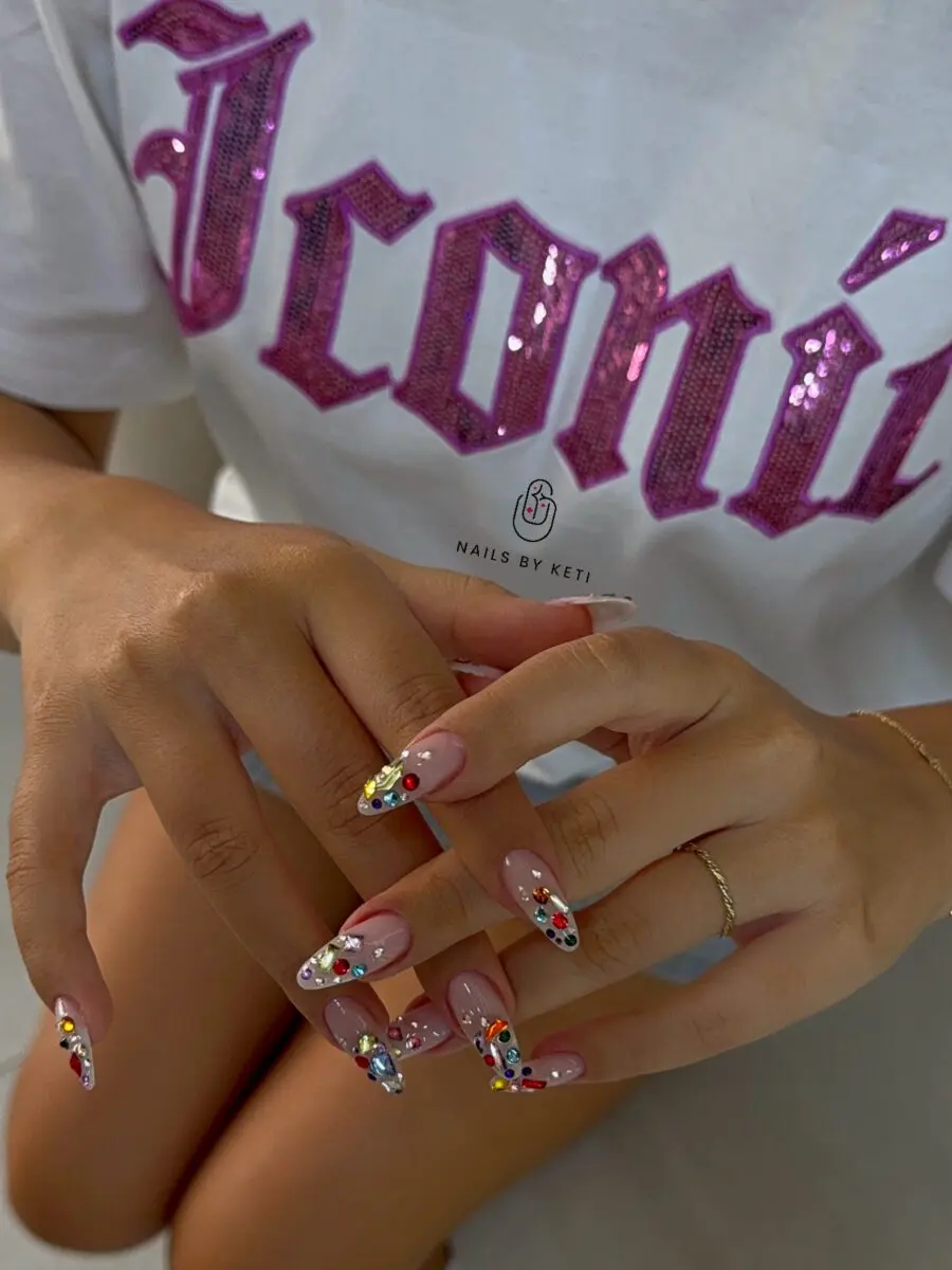 Stylish almond nails adorned with colorful rhinestones