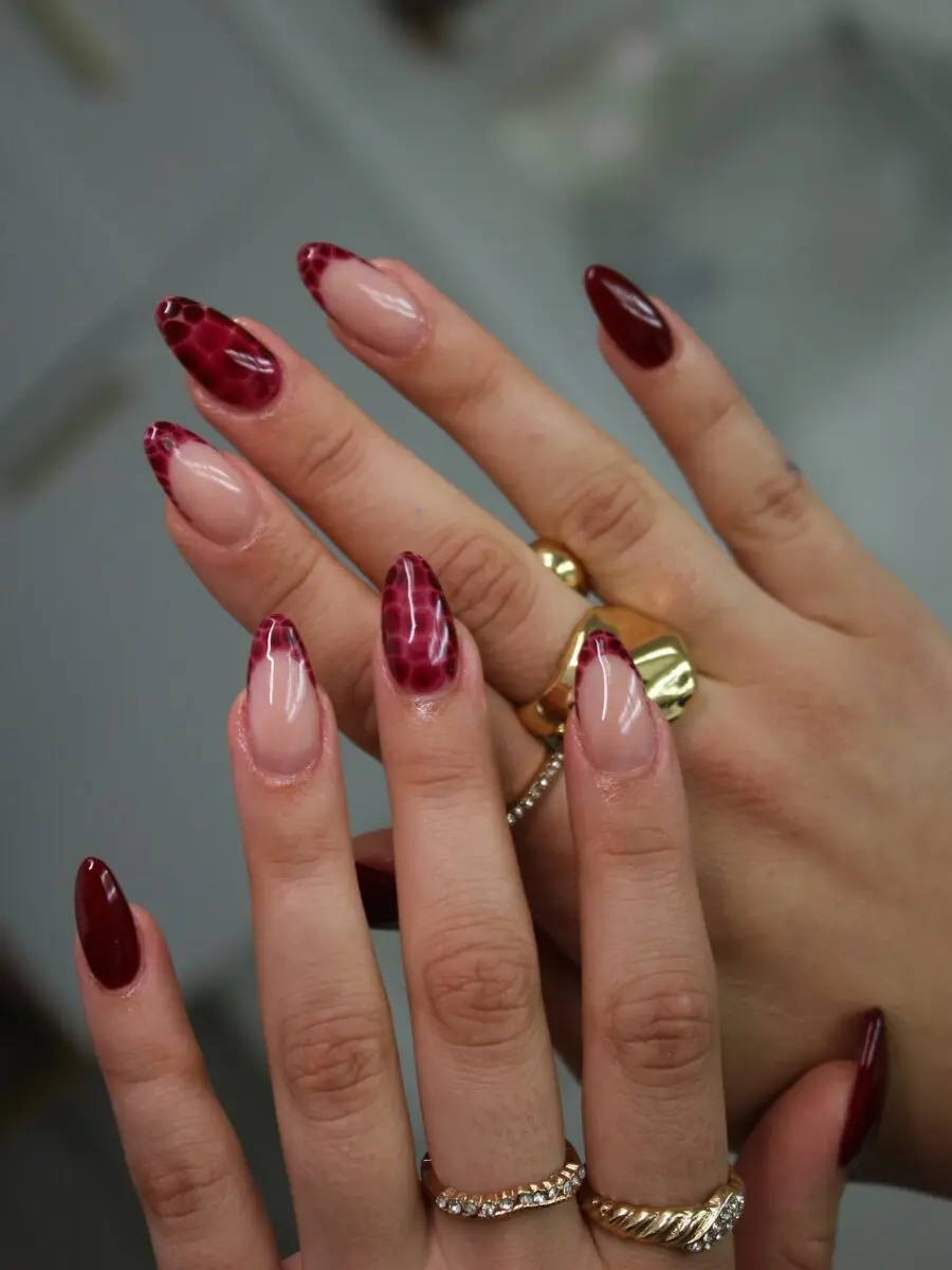 Stylish almond nails with glossy red patterns