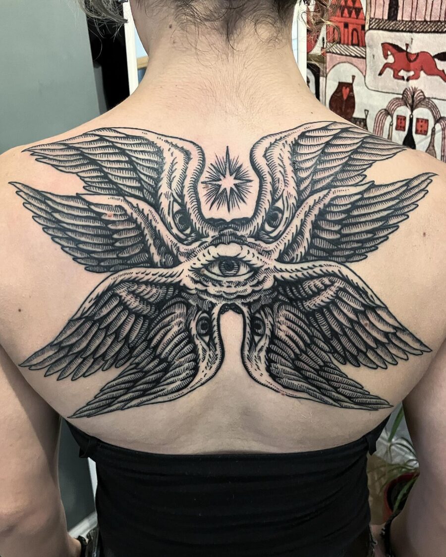 Stunning back tattoo with wings and an eye