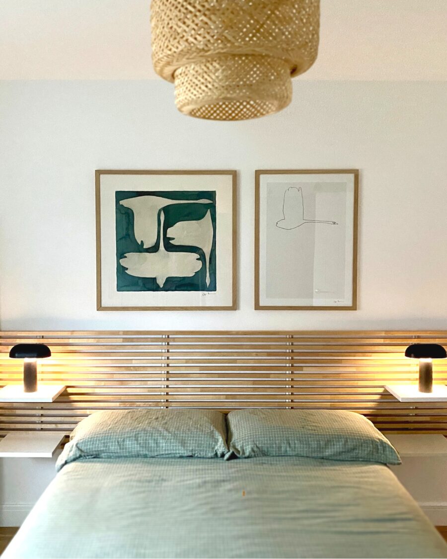 Elegant bed decor with modern artwork and lighting