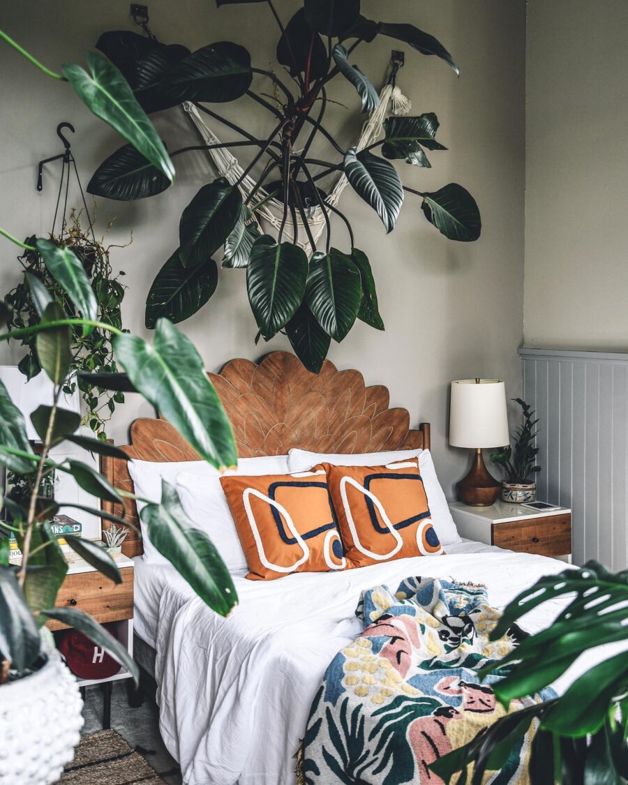 Bohemian-inspired bedroom with lush greenery