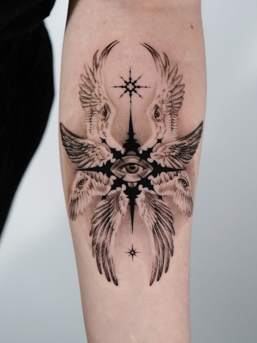 Intricate tattoo featuring wings and an eye
