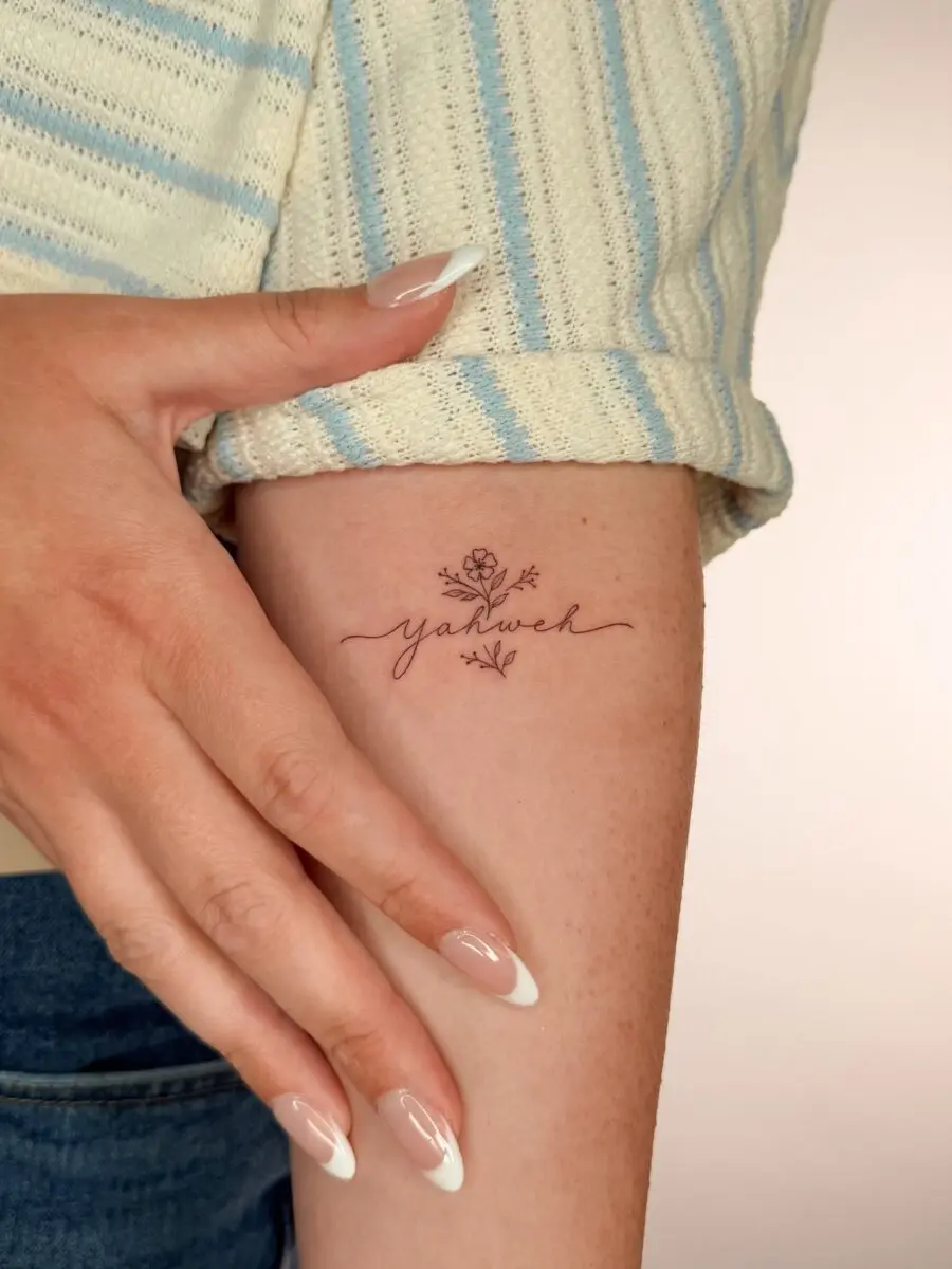 Delicate Yahweh Tattoo with Floral Touch