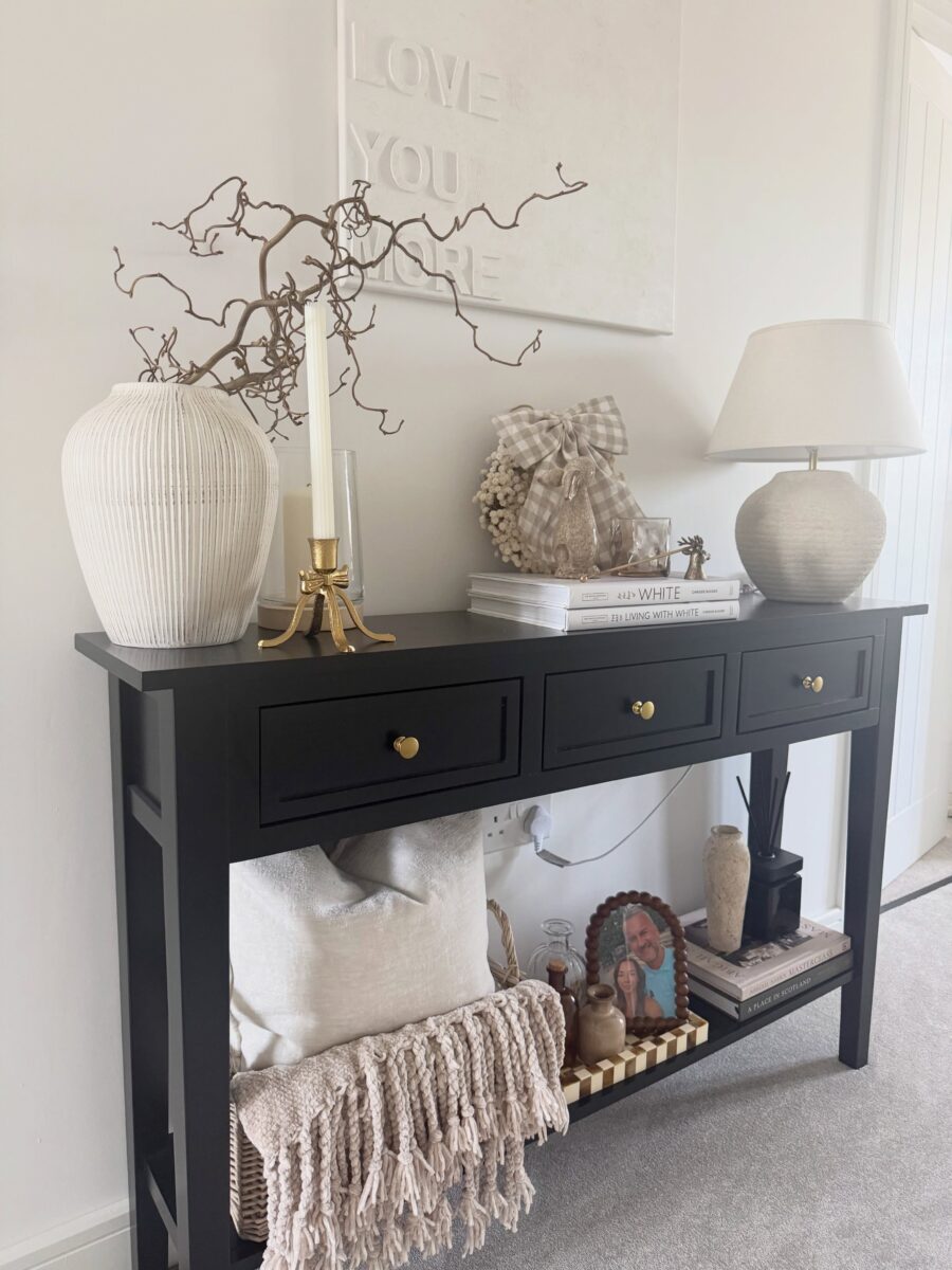 Stylish black entryway table with decorative accents