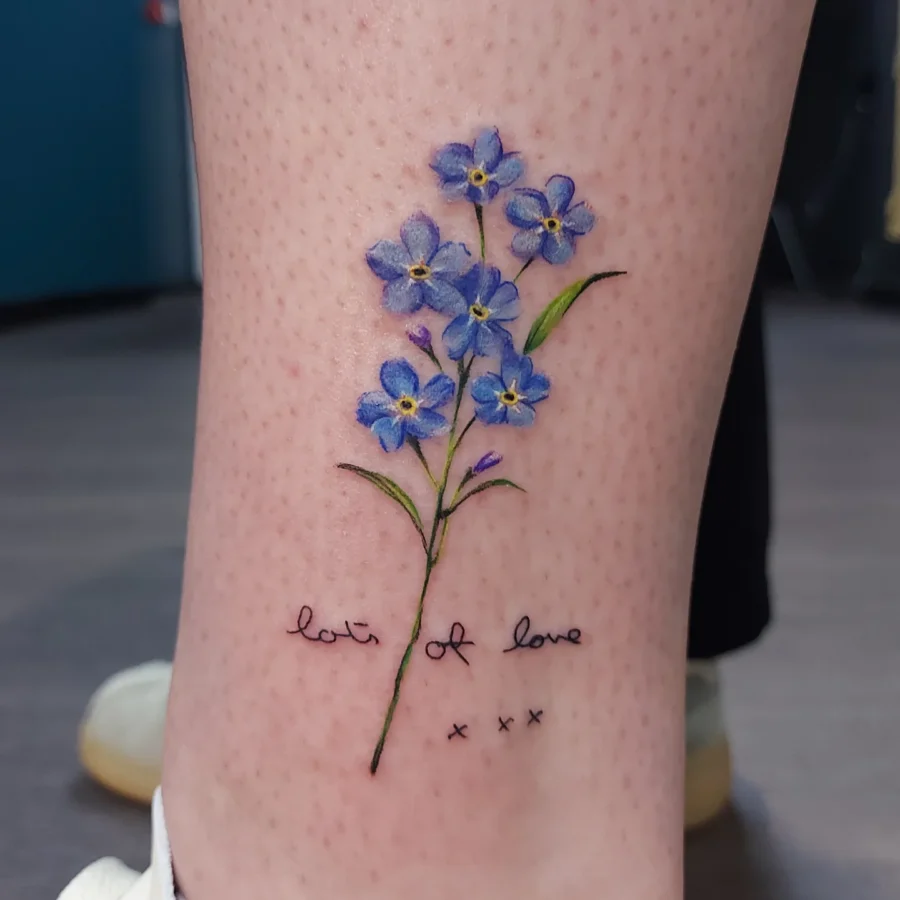 Elegant forget-me-not floral tattoo with sentiment