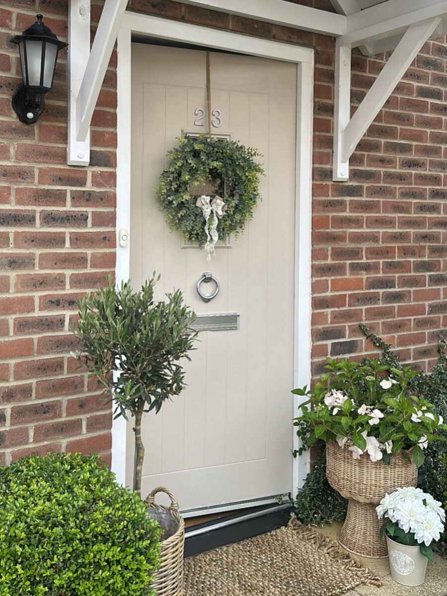 Welcoming entrance with lush greenery and charm