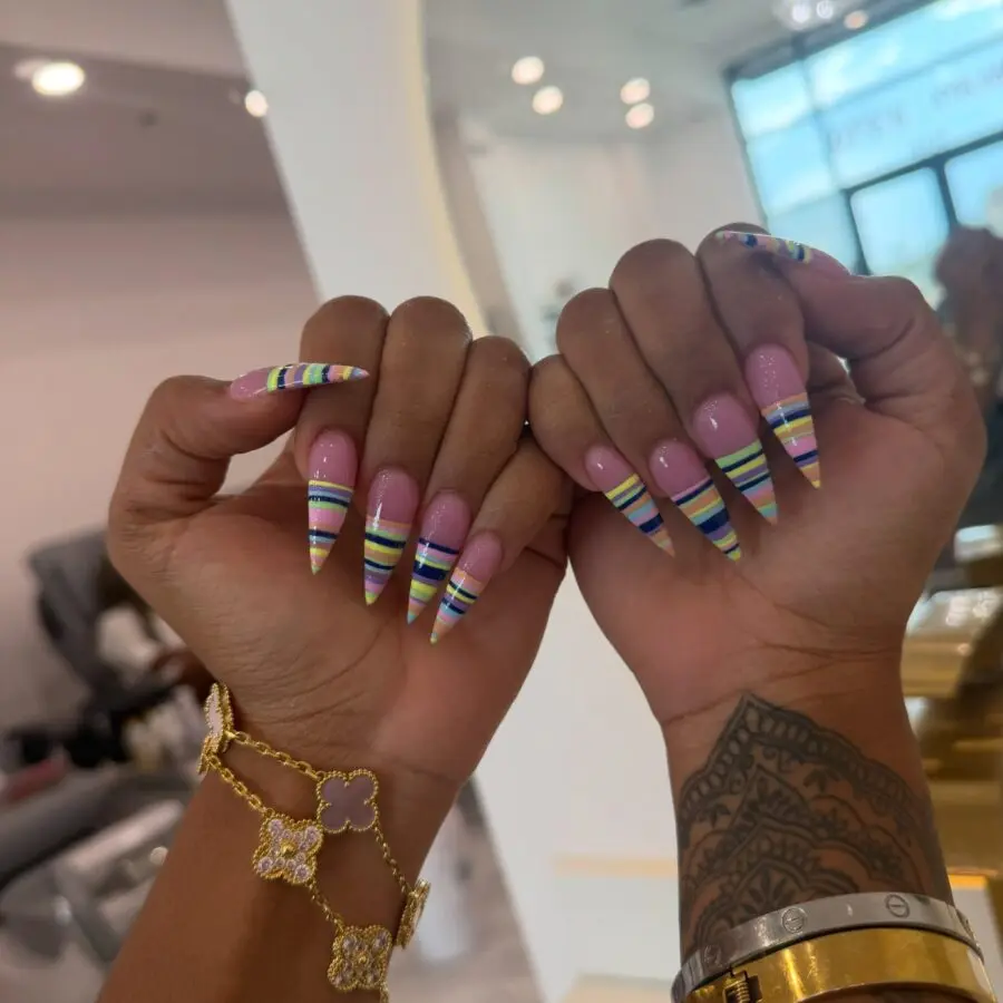 Vibrant stiletto nails with striped accents