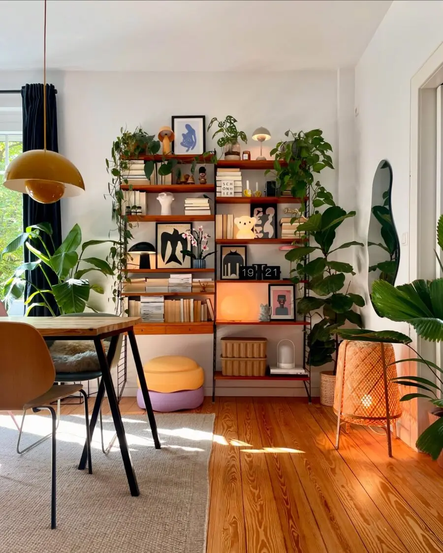Stylish shelf with greenery and warm lighting