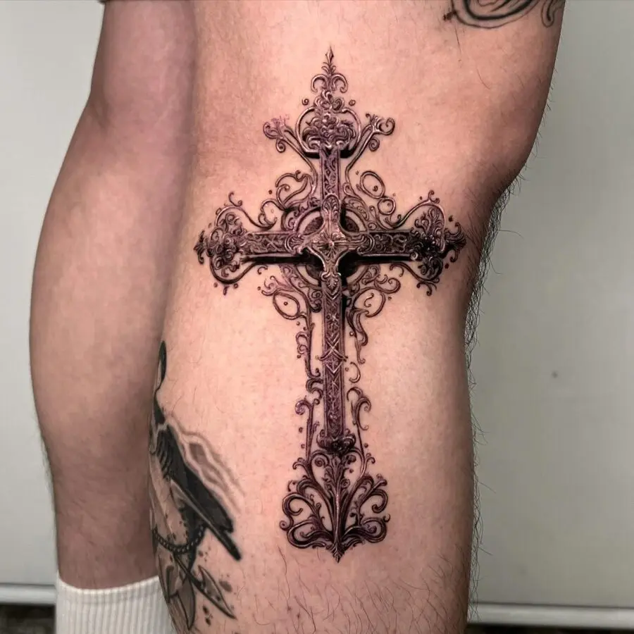 Intricate cross tattoo with ornate details