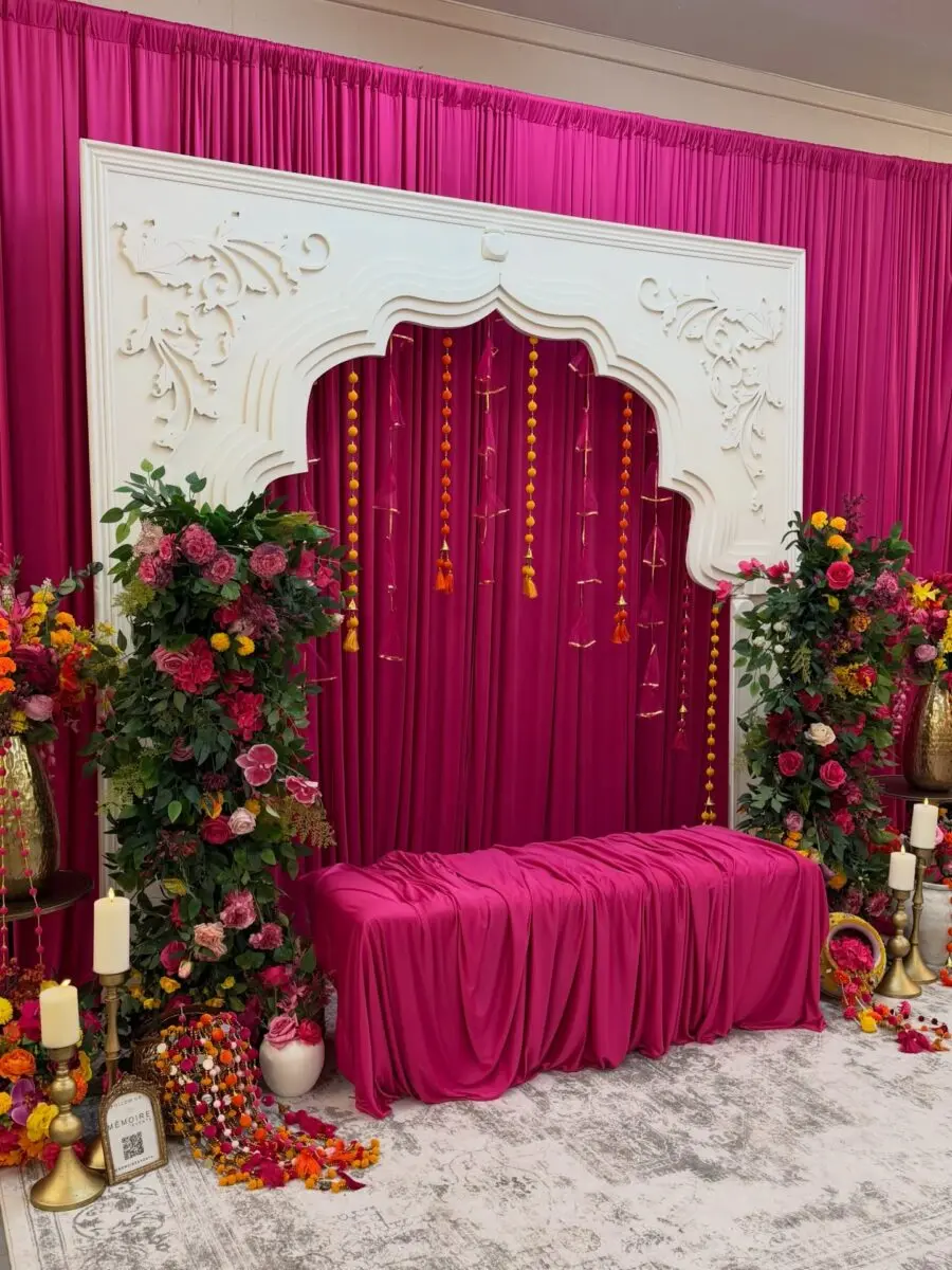 Vibrant pink backdrop with lush floral accents