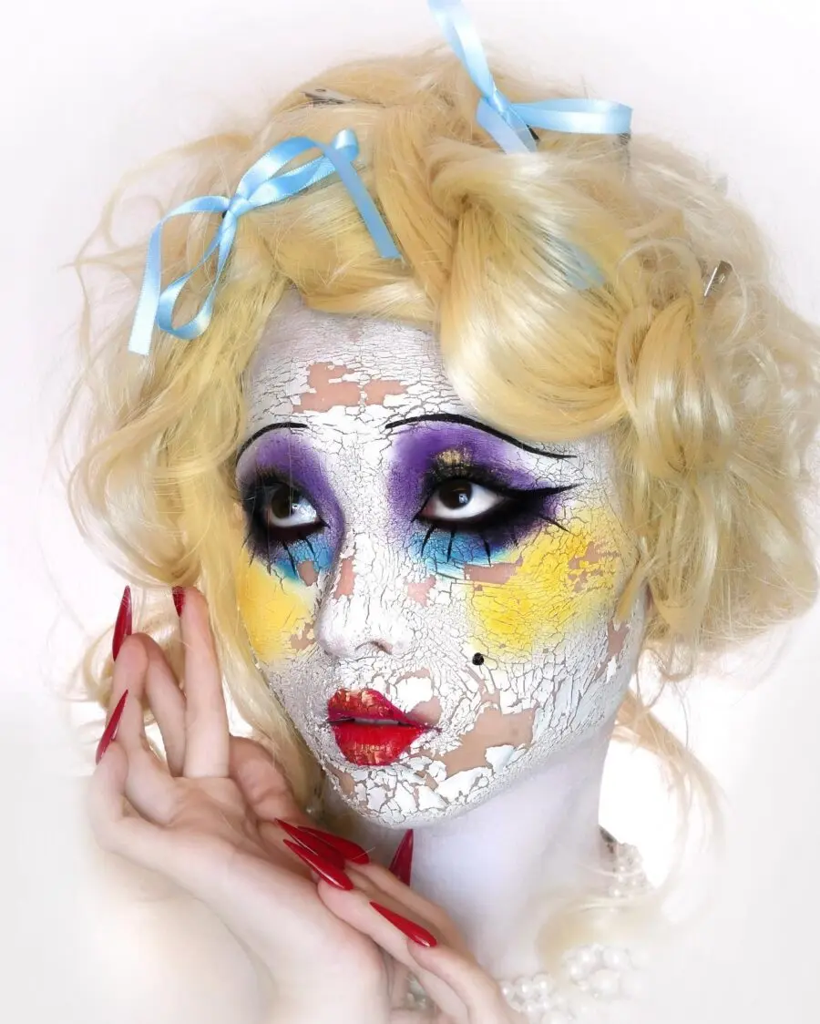 Whimsical doll makeup with cracked paint effect