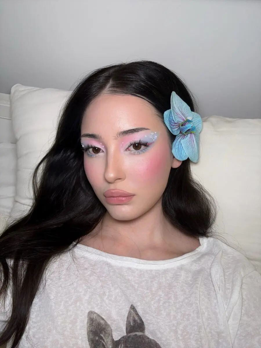 Whimsical doll makeup with floral accents