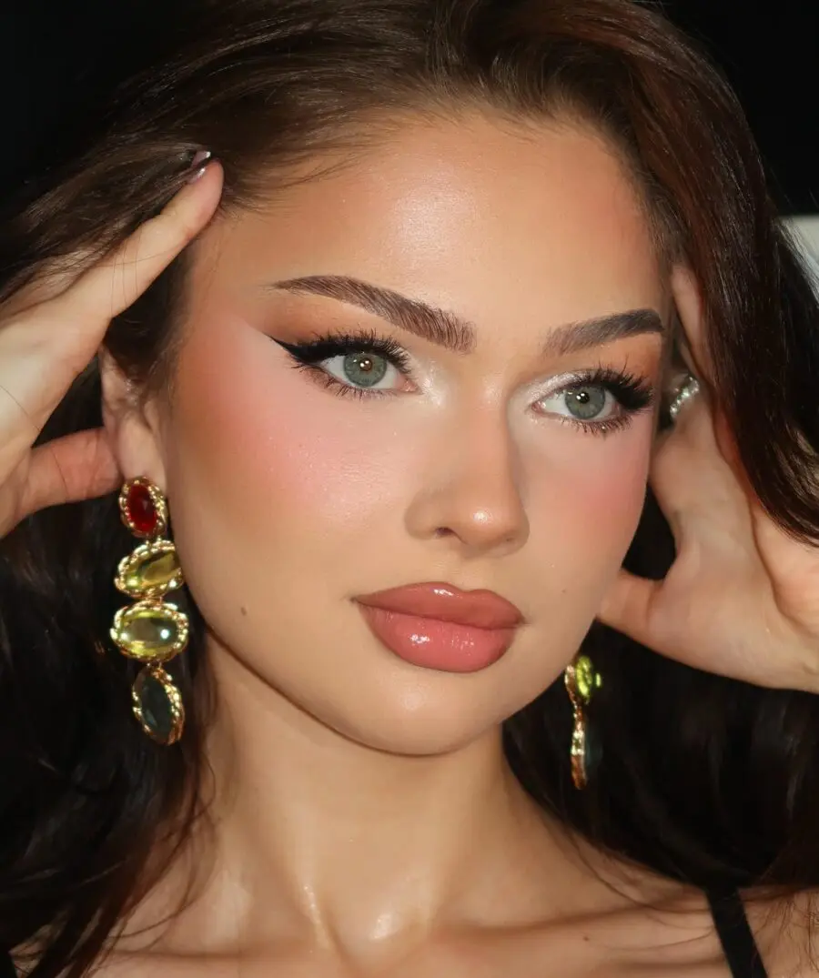 Glam doll makeup with bold eyes and glow