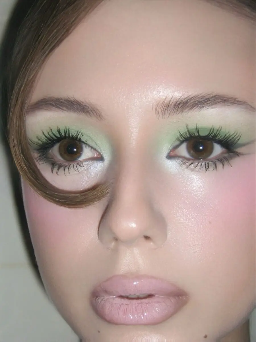 Vibrant green doll makeup with soft pastels