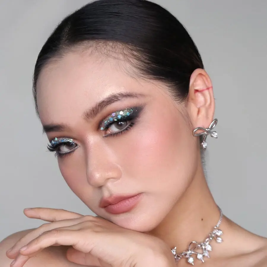 Stunning doll-inspired makeup with sparkling accents