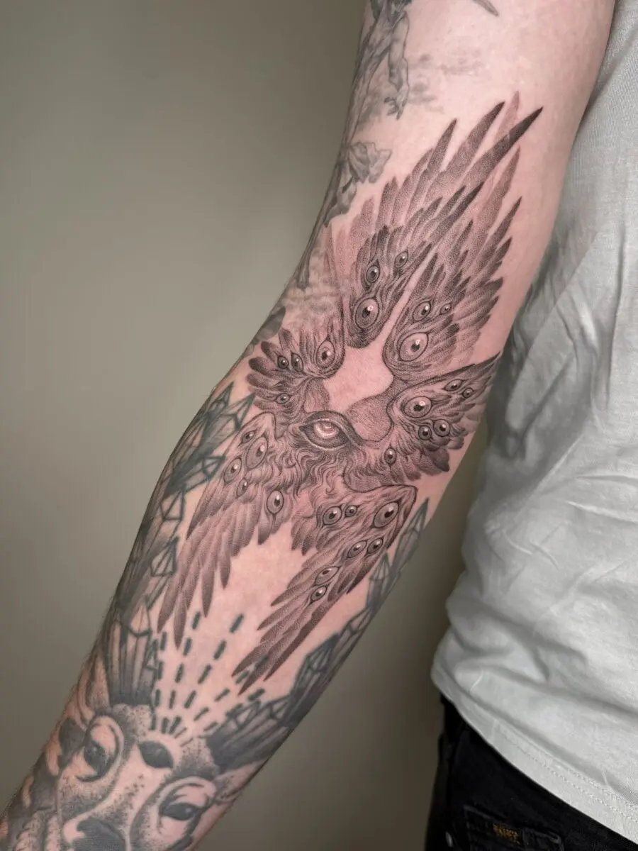 Intricate eagle wings with mysterious eye motif