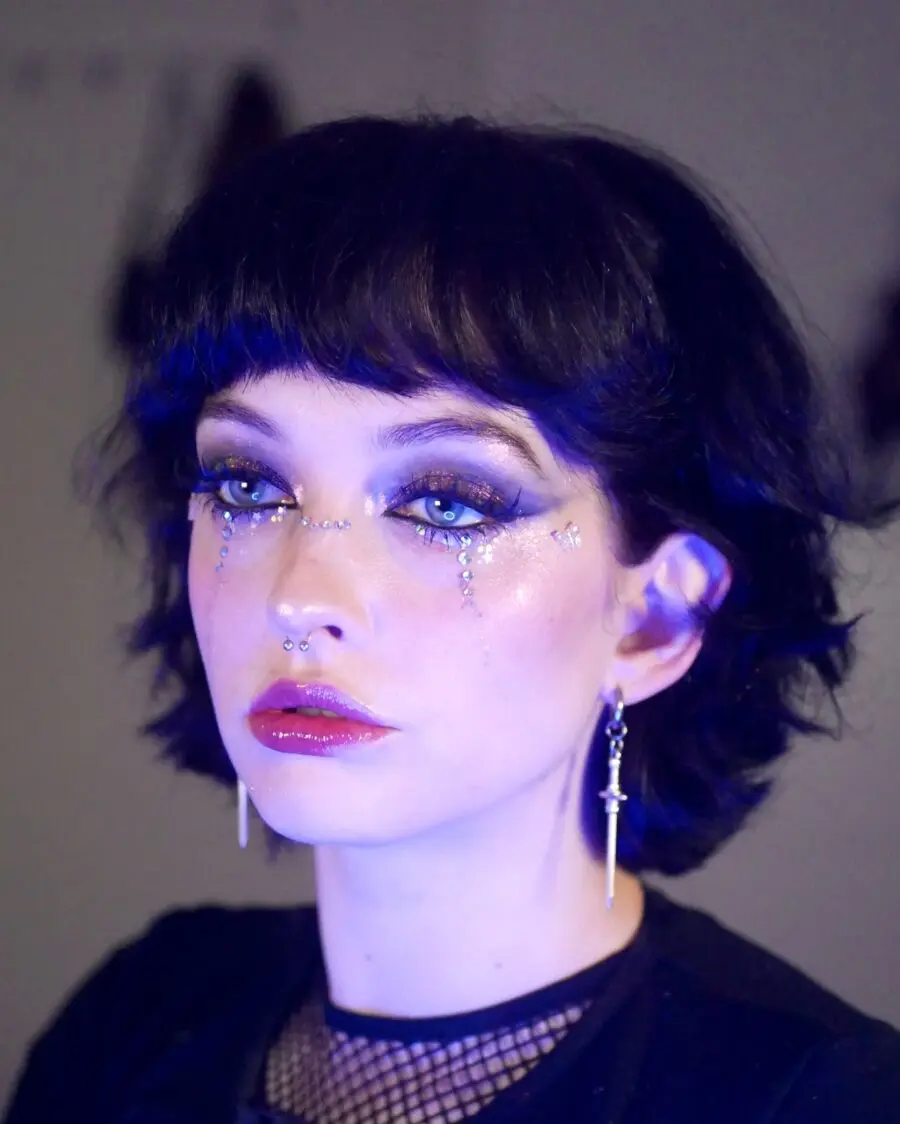 Glittery blue eyes with bold eyeliner accents
