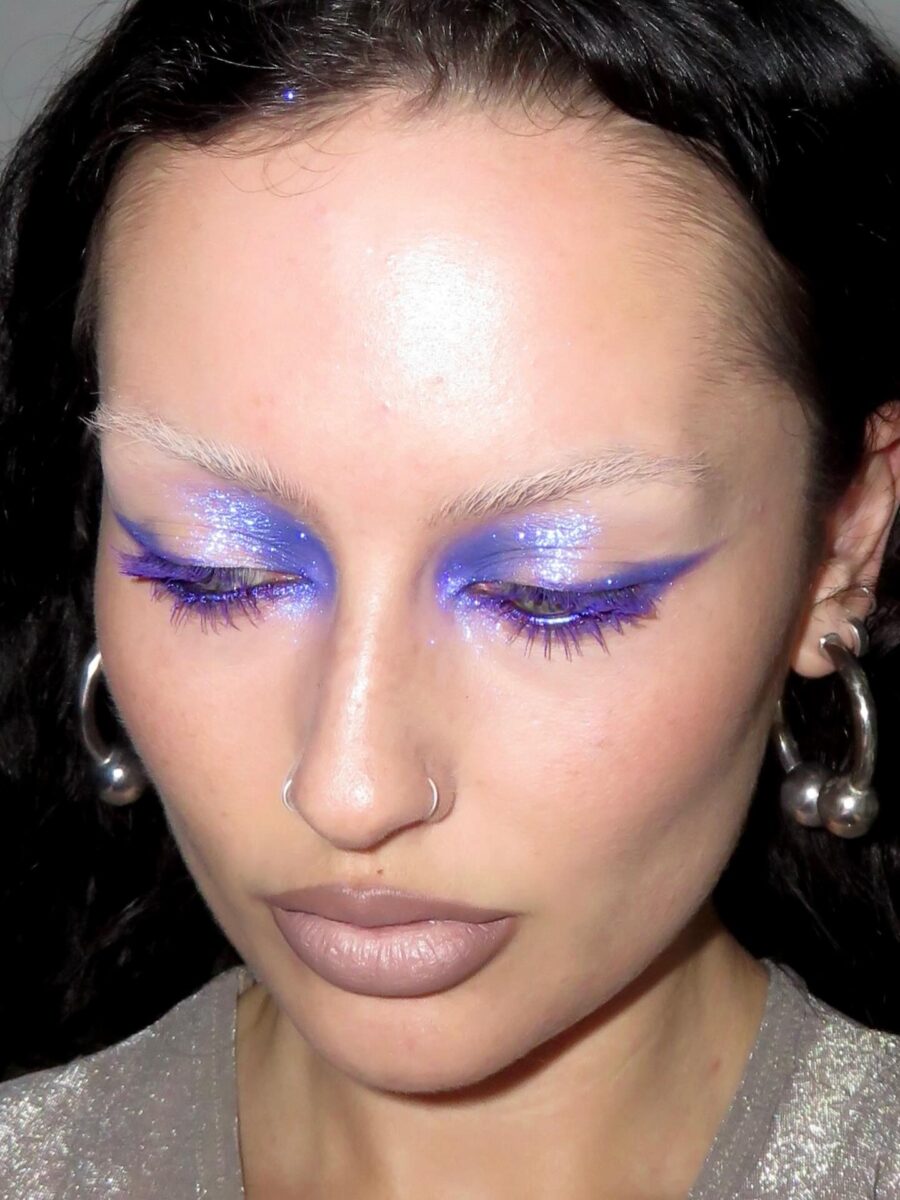 Bold blue eyeliner and shimmering glitter details