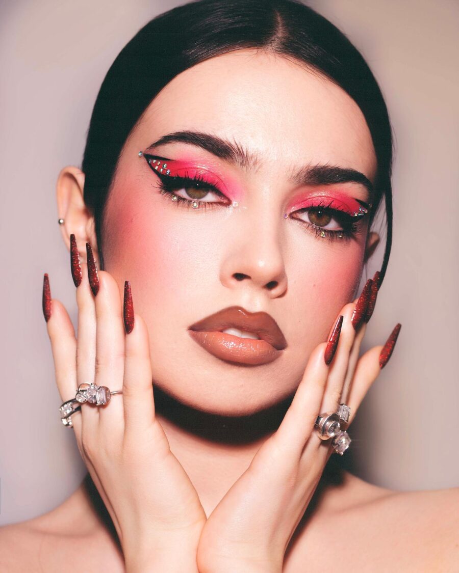 Striking red glam makeup with dazzling accents