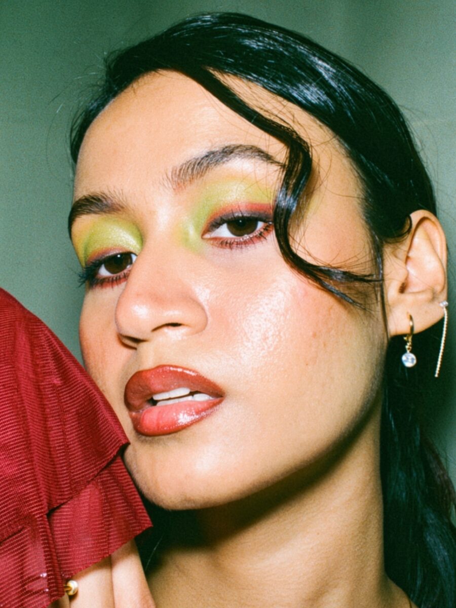 Vibrant green eyeshadow with glossy lips