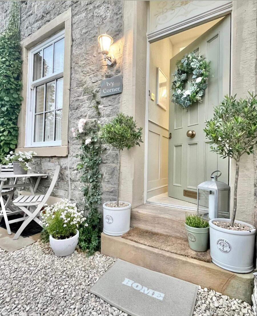 Charming front door with floral wreath and greenery