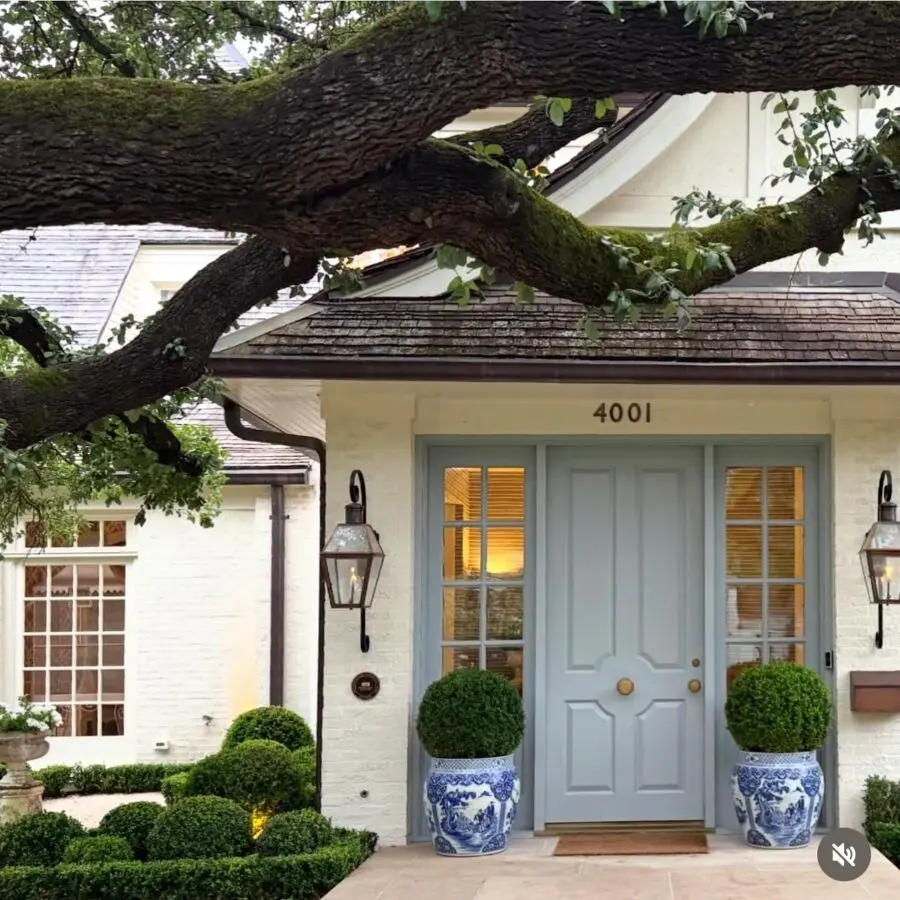 Charming entrance with lush greenery accents