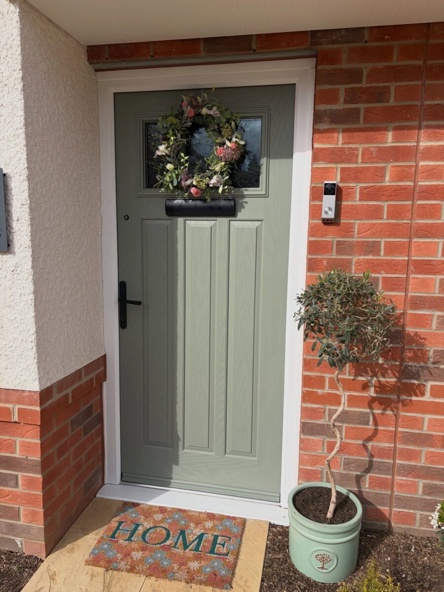 Charming front door with welcoming greenery