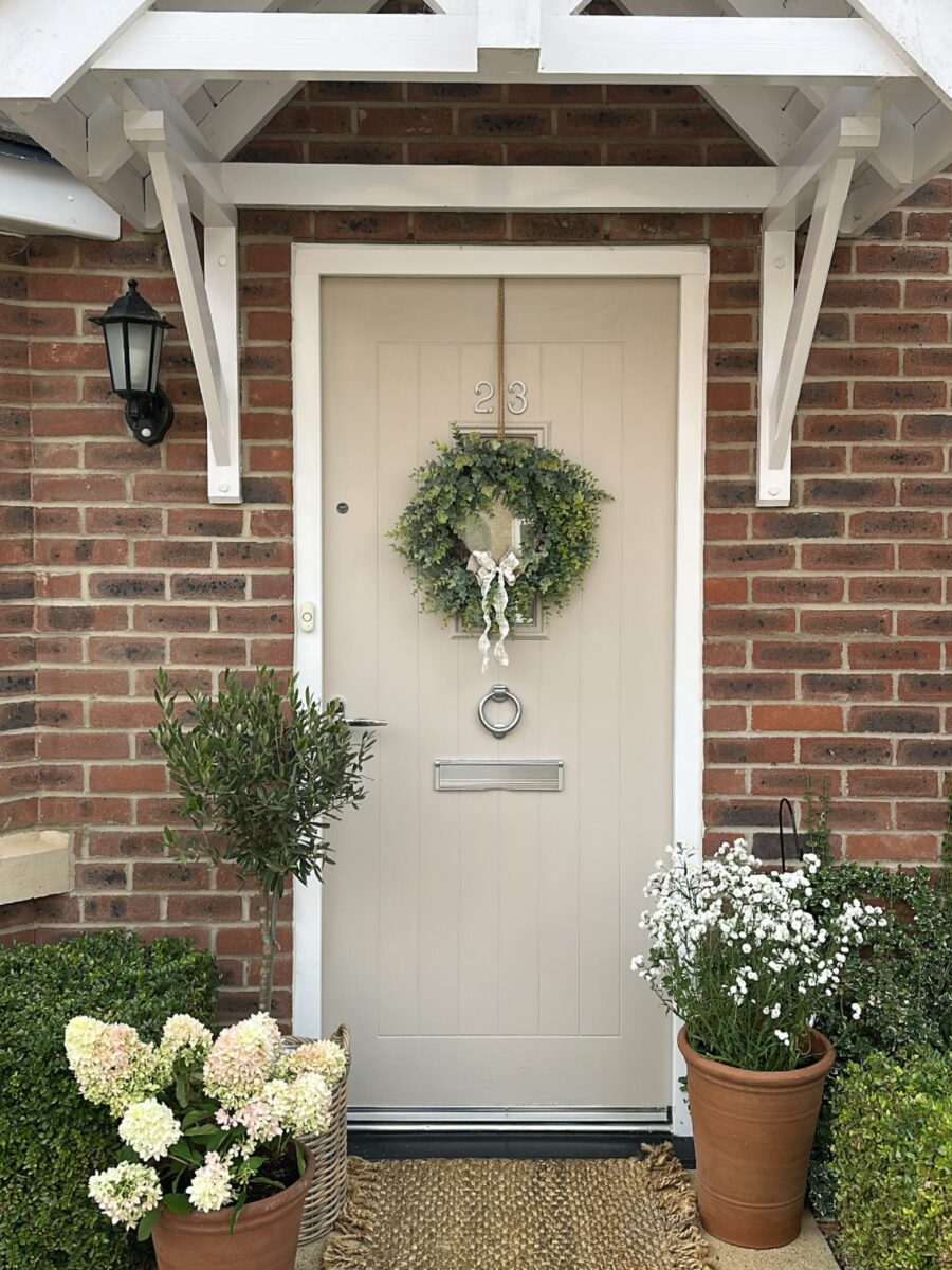 Charming entrance with welcoming greenery accents