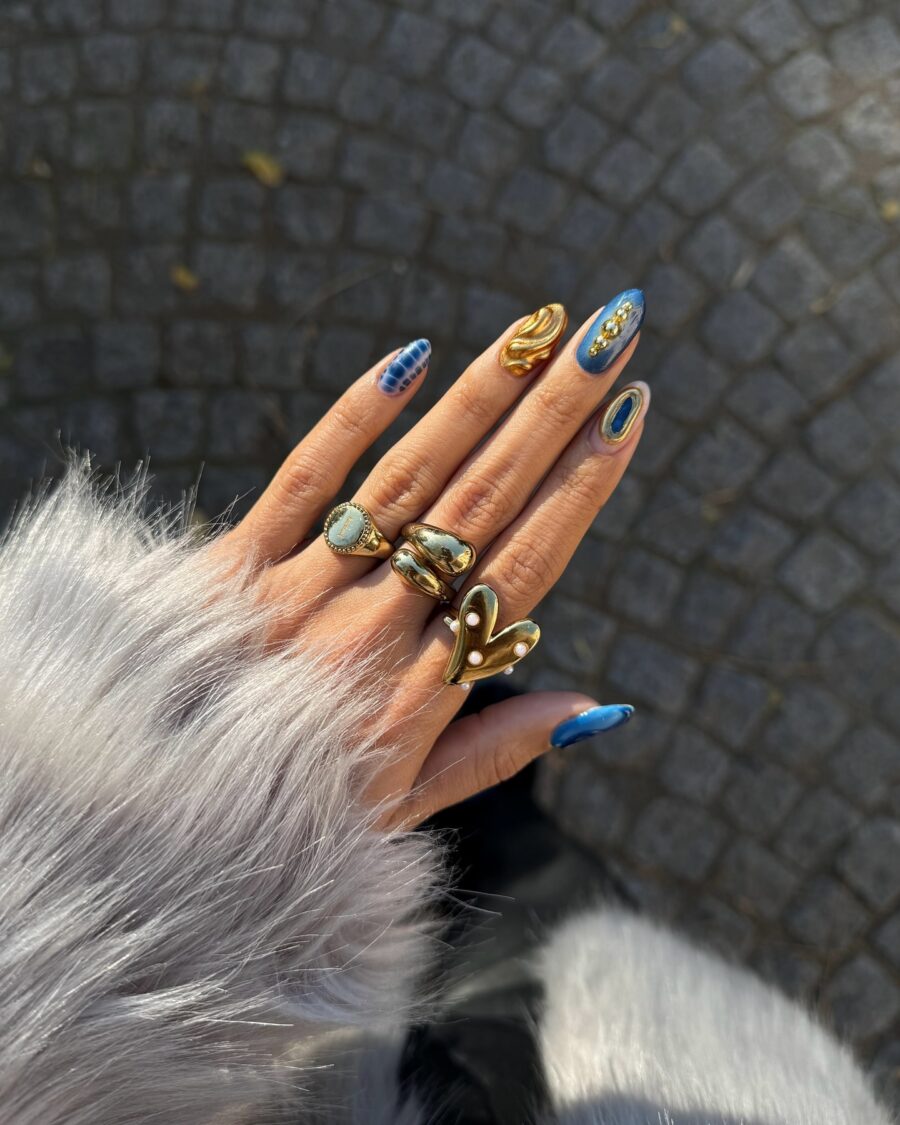 Stylish blue nails adorned with gold accents