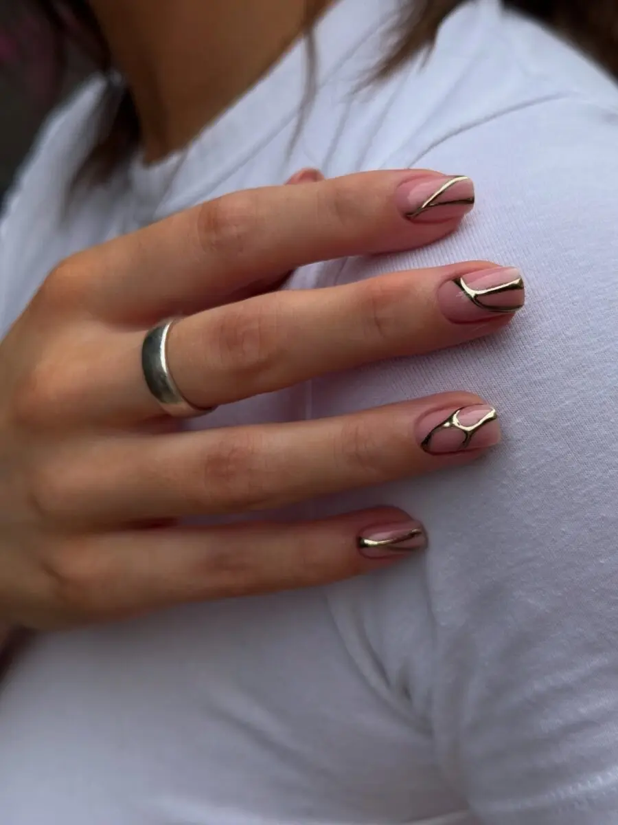 Elegant gold line design on nude nails