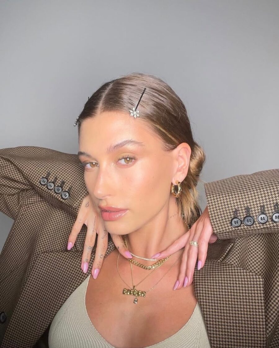 Elegant pink manicure with chic accessories.