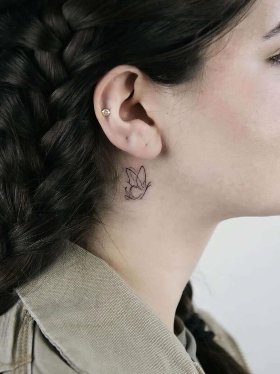 Delicate floral tattoo near the ear
