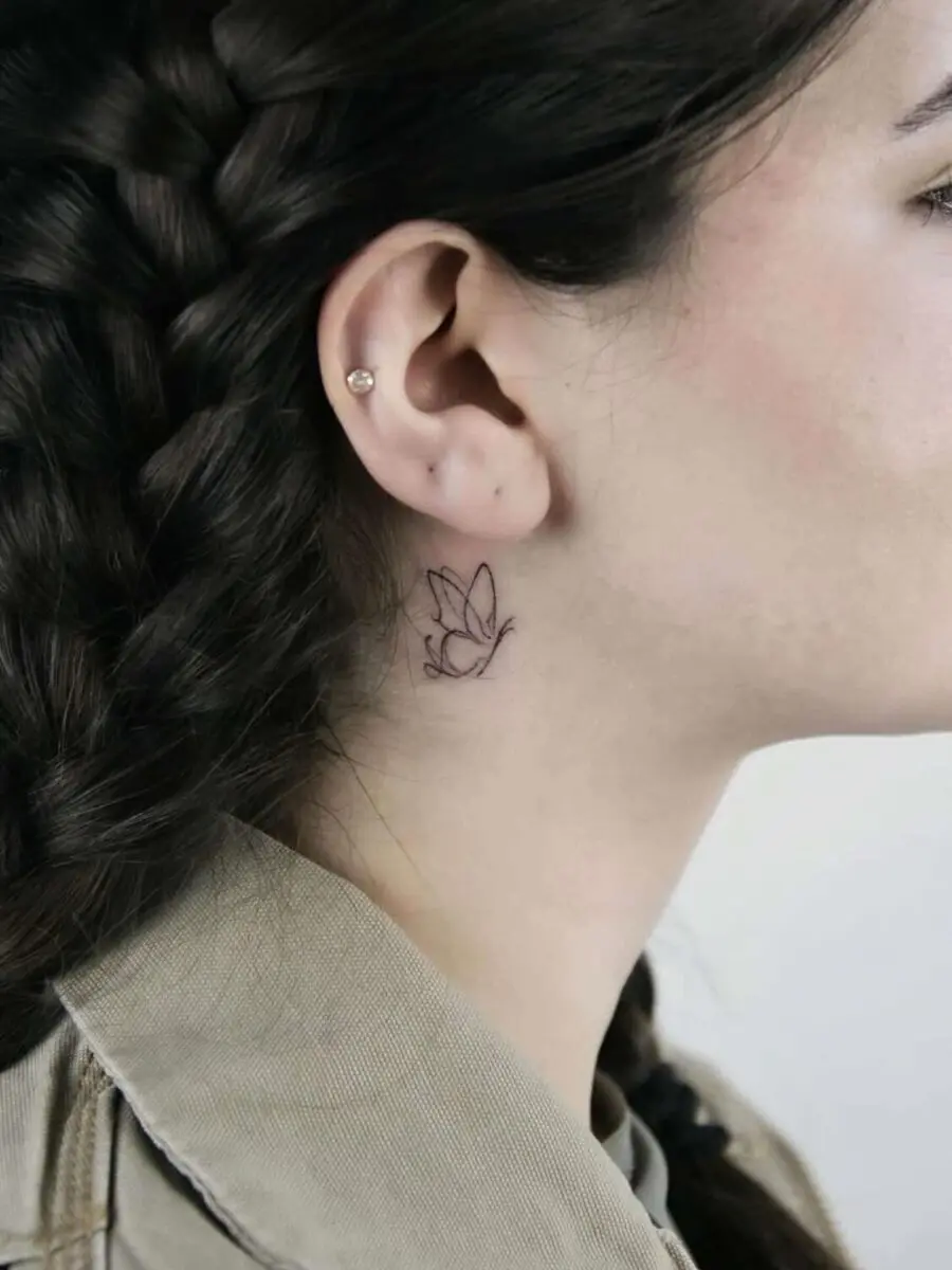 Delicate floral tattoo near the ear