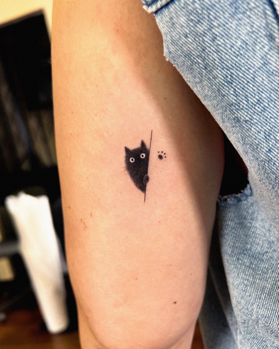 Cute hidden tattoo of a peeking kitten