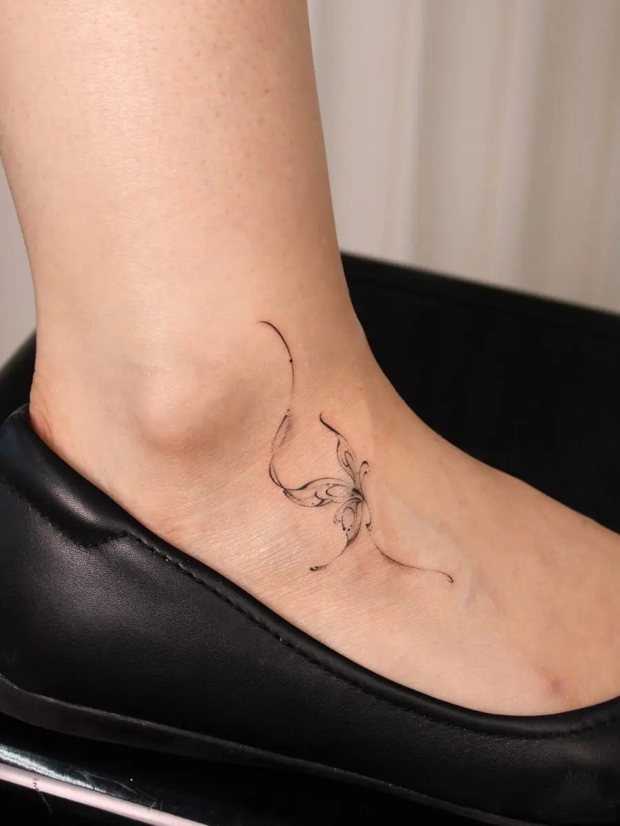 Subtle butterfly tattoo on the ankle area