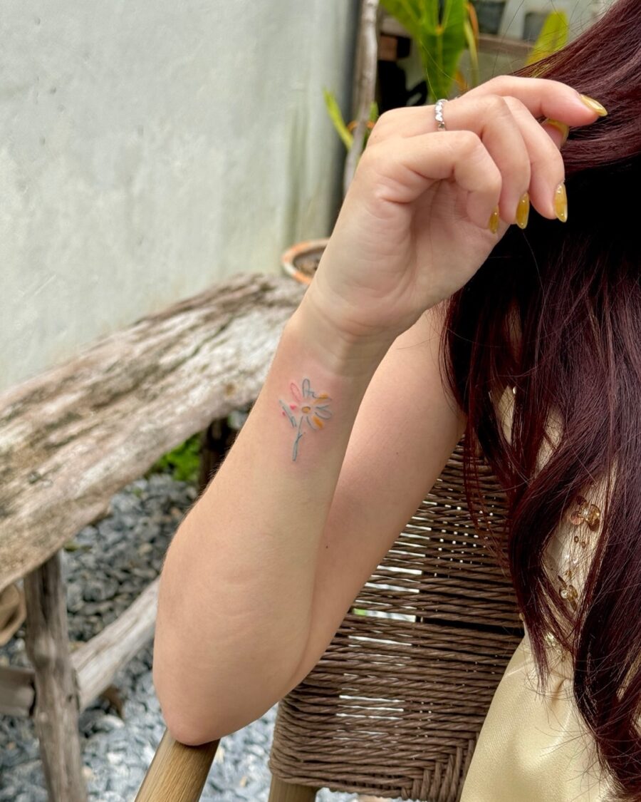Delicate floral tattoo subtly hidden on arm