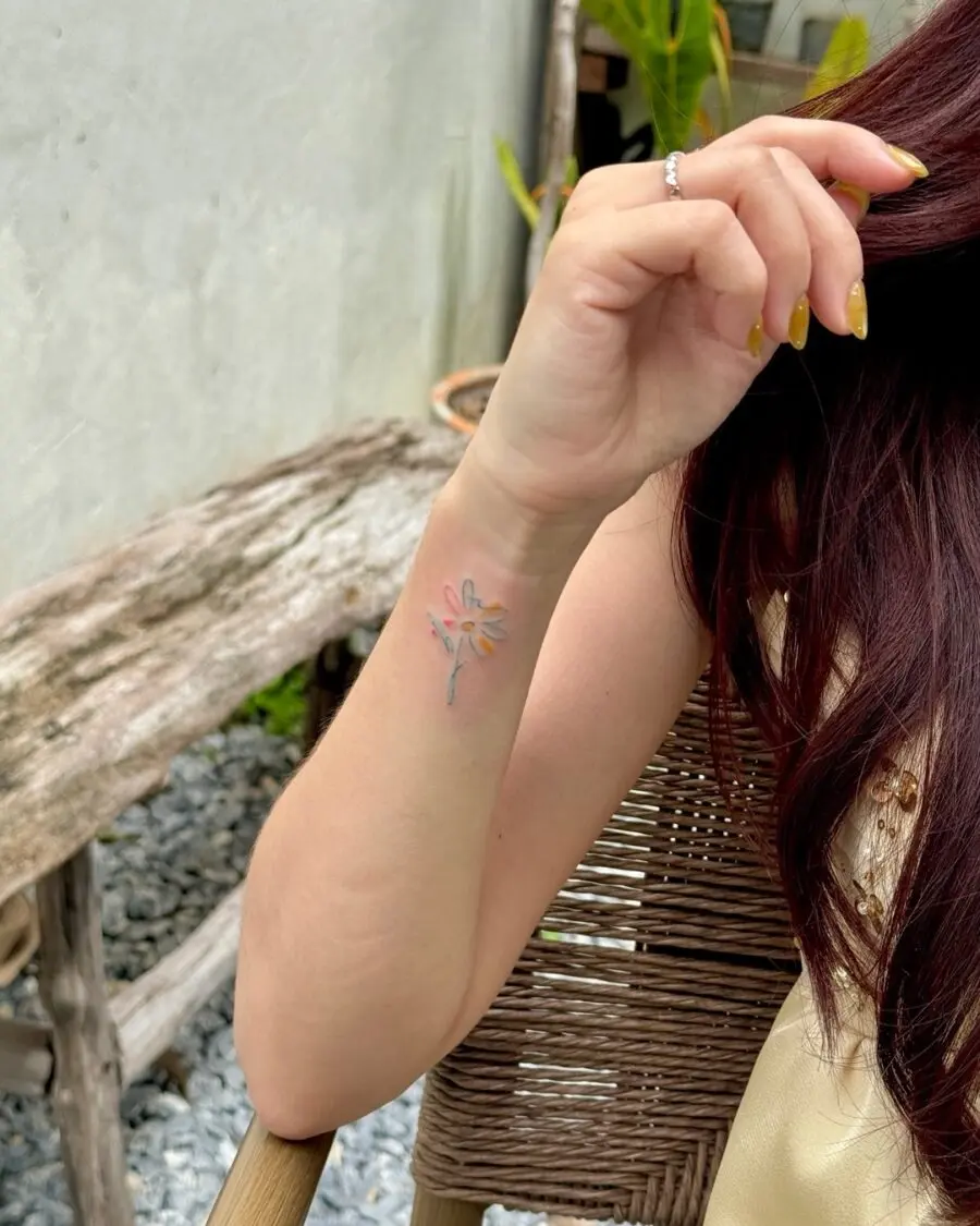 Delicate floral tattoo subtly hidden on arm