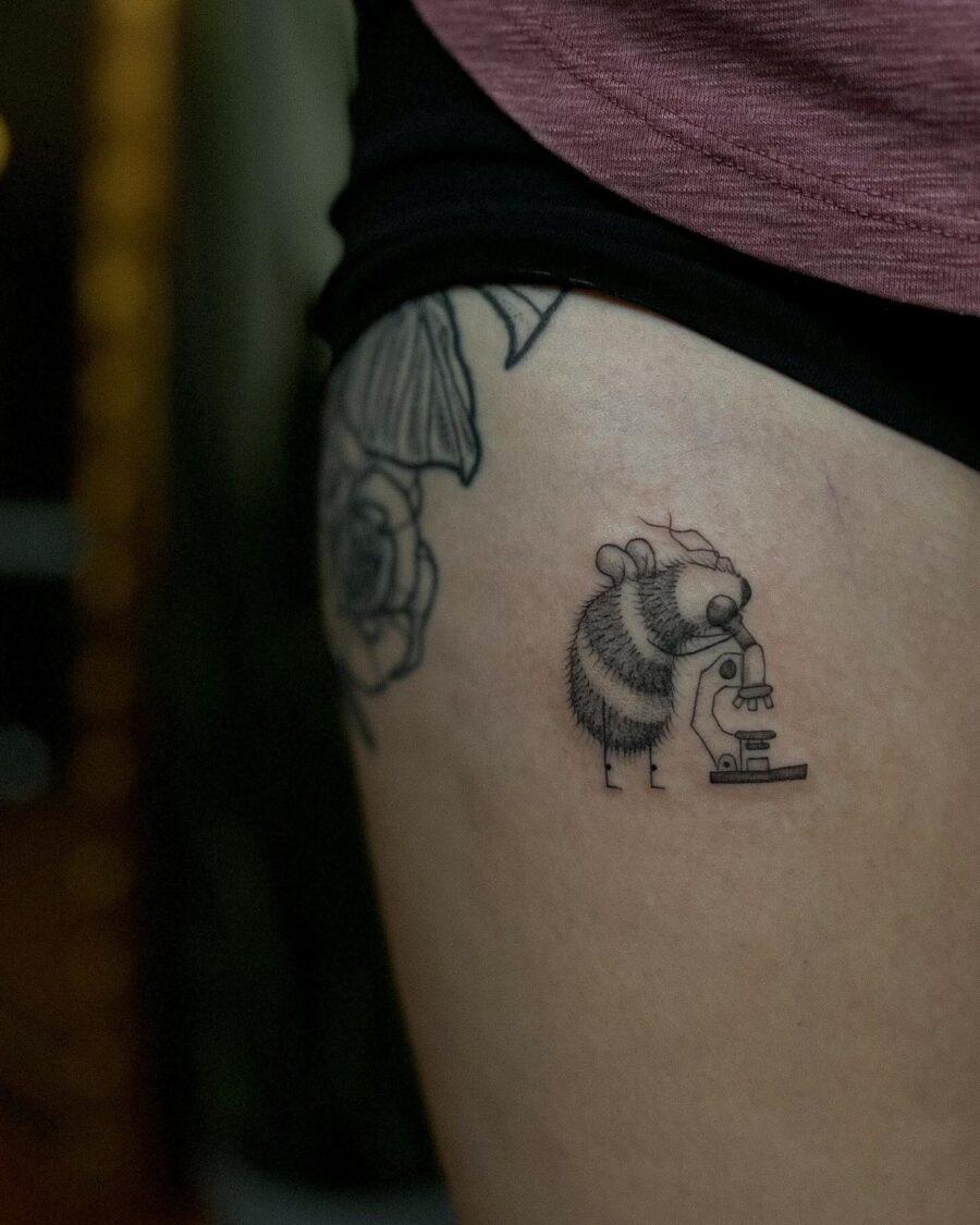 A quirky tattoo featuring a bee scientist