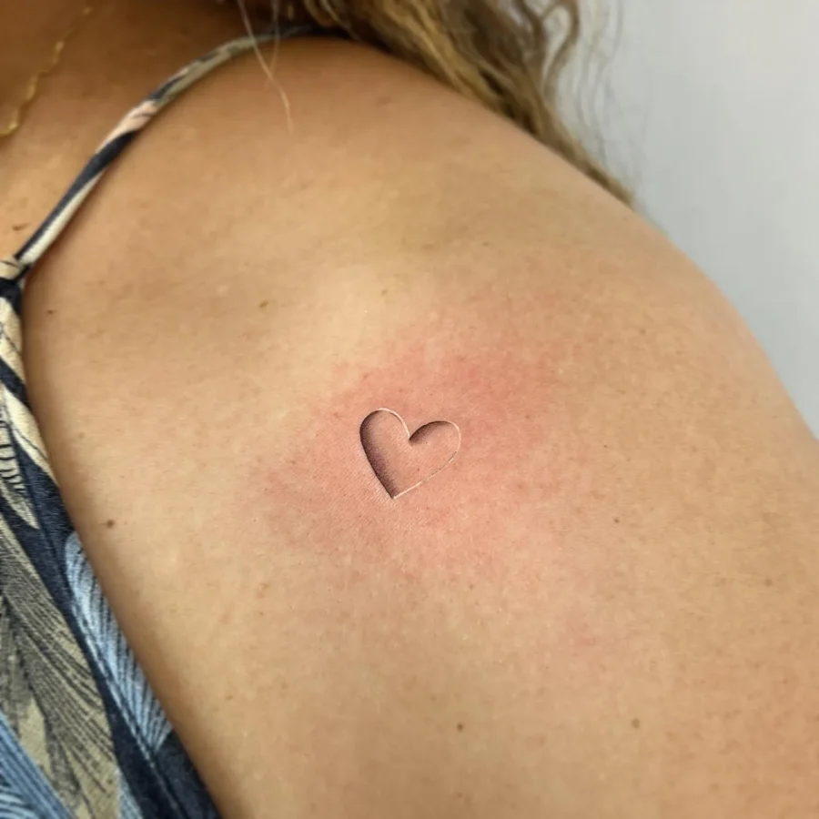 Delicate heart hidden tattoo on skin
