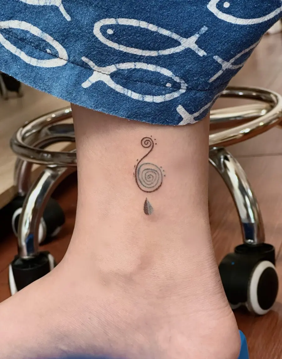 A captivating spiral tattoo on the ankle.