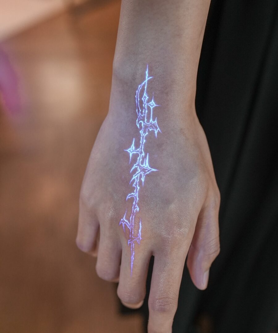 Electric blue hidden tattoo on hand